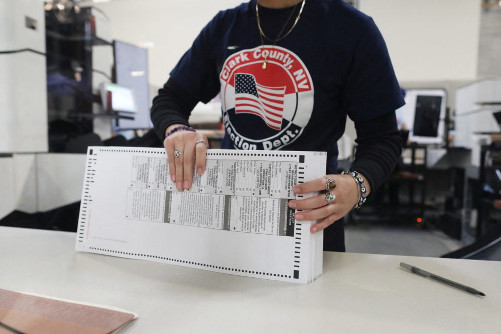 A worker sorts through ballots in the delayed processing at the Clark County Election Department for the Nevada midterm elections in Las Vegas, Nevada, U.S. November 9, 2022.  REUTERS/David Swanson