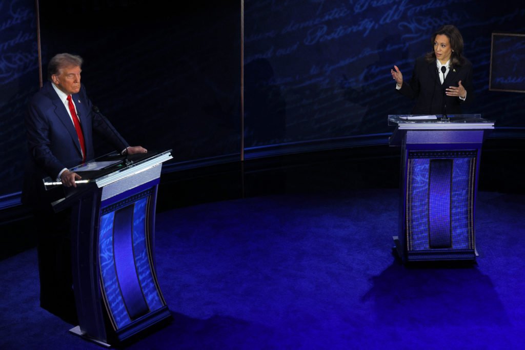 Democratic presidential nominee, U.S. Vice President Kamala Harris gestures as she speaks while Republican presidential nominee, former U.S. President Donald Trump listens, during a presidential debate hosted by ABC in Philadelphia, Pennsylvania, U.S.,  September 10, 2024 REUTERS/Brian Snyder