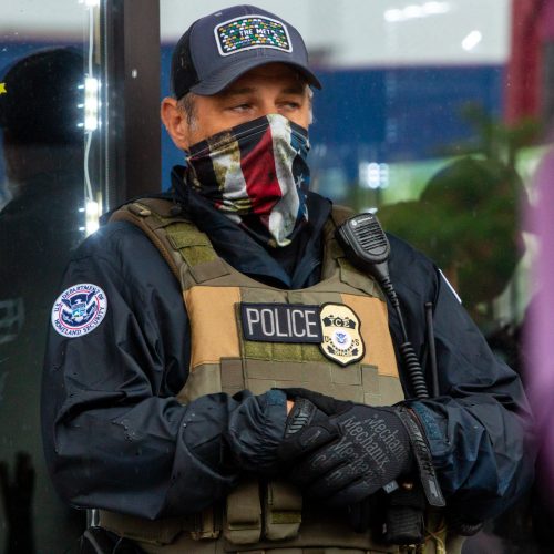 An ICE agent stands guard outside as ICE, other federal officers, Minneapolis police, and other state officers raid Las Cuatro Milpas in Minneapolis, Minnesota Tuesday, June 3, 2025. (Photo by Nicole Neri/Minnesota Reformer)